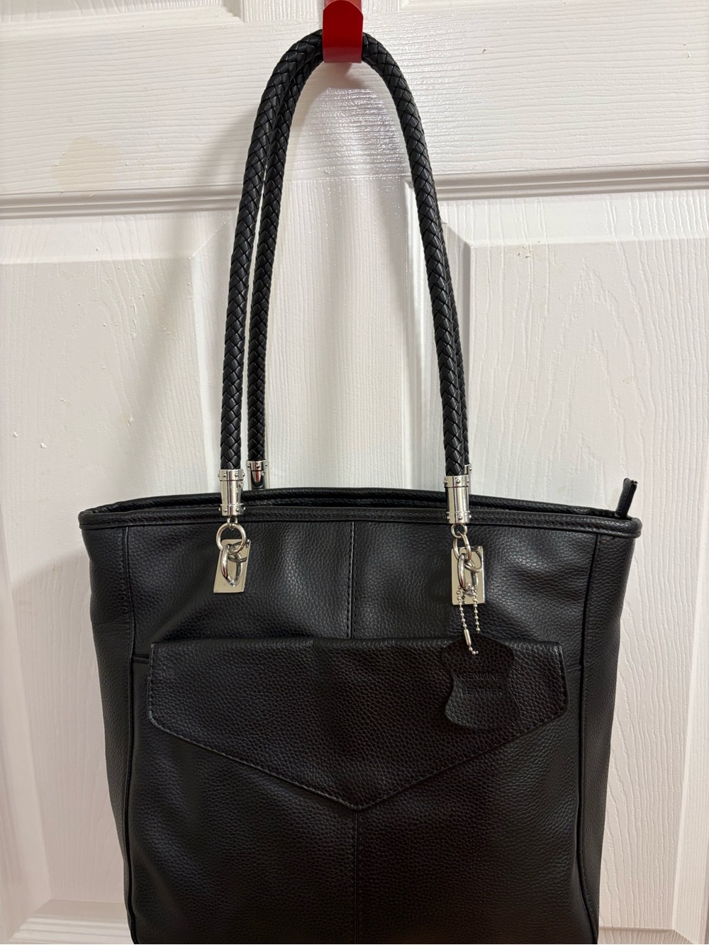 Genuine leather shoulder tote bag with dual braided straps and a fold over pocke